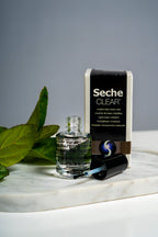 Seche Clear Crystal Clear Base Coat bottle and box on a marble tray with green leaves
